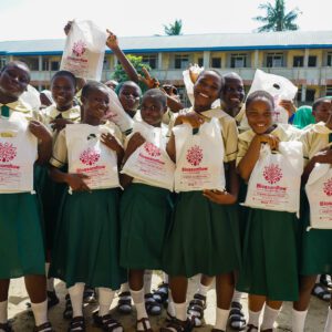 Young Nigerian secondary school girls receiving 6 months supply of sanitary pads during Blossomflow Foundation's Monthly Cycle Initiative Outreach.