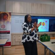 Dr. Joan Faluyi of BlossomFlow Foundation presenting on driving social change.