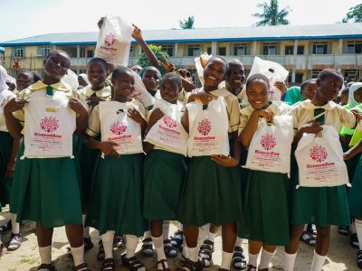 Young Nigerian secondary school girls receiving 6 months supply of sanitary pads during Blossomflow Foundation's Monthly Cycle Initiative Outreach.